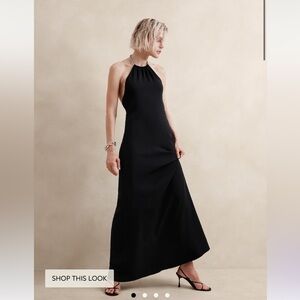 Long black dress, high neck with silver chain neckline and open back